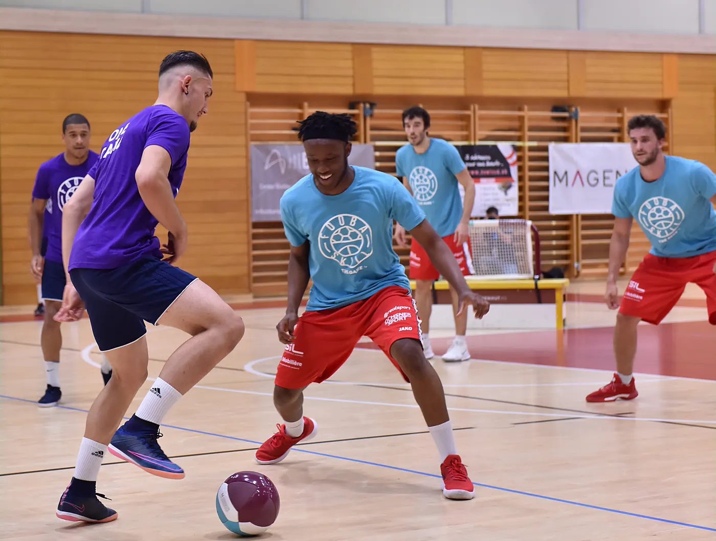 Students playing FooBaSKILL, switching between feet and hands during a PE class